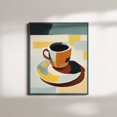 a coffee cup and saucer sitting on top of a white plate next to a wall