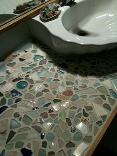 a white sink sitting on top of a bathroom counter next to a bowl shaped sink