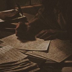 a person sitting at a table with lots of papers