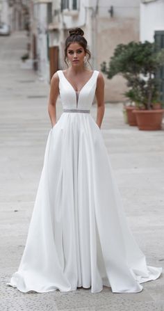 a woman in a white dress standing on the street with an instagram message above her