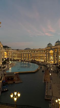 a large building that is next to a body of water in the middle of a city