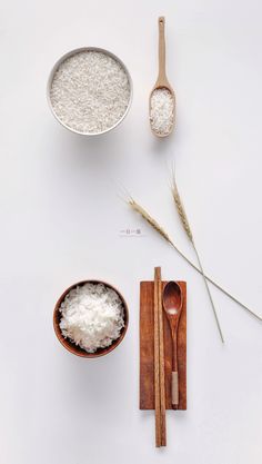 rice and wooden spoons on a white surface