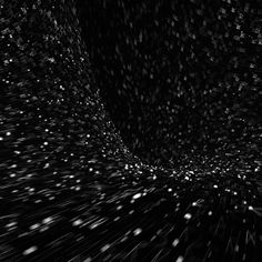 an abstract black and white photo with stars coming out of the center, in space