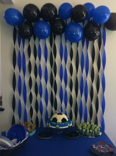 a blue table with black and white balloons