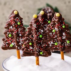 three chocolate christmas trees sitting on top of a white plate