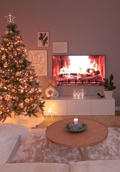 a living room with a christmas tree and fireplace