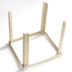 a small wooden stand on a white surface with no one in it's place