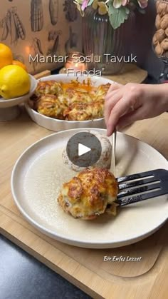 a person is cutting into some food on a plate