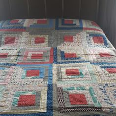 a bed with a quilt on top of it