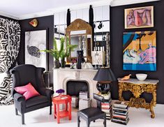 a living room filled with furniture and paintings on the wall above it's fireplace