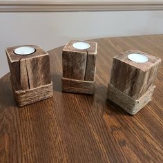 three wooden candles sitting on top of a table