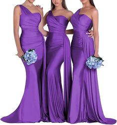 three women in long purple dresses standing next to each other with their arms around each other