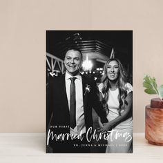 a black and white photo with the words married christmas on it next to a potted plant