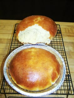 two loaves of bread sitting on top of a cooling rack