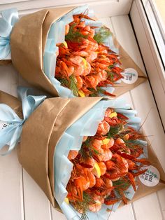 two brown paper bags filled with shrimp on top of a white door sill next to each other