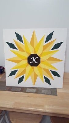 a card with the letter k on it sitting on top of a wooden table next to a pair of shoes