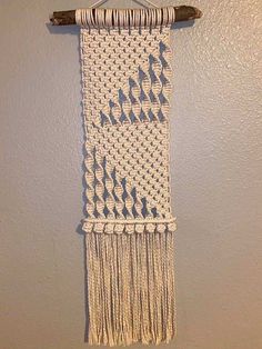 a crocheted wall hanging on the wall