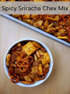 two bowls filled with chex mix next to each other on top of a table