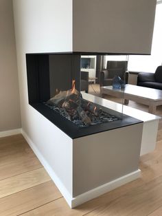 a modern fireplace in the middle of a living room