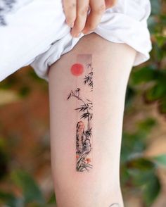 a woman's arm with a tattoo on it that has an image of a bamboo tree