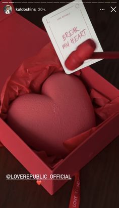 a red heart in a box with a note attached to it that says break my heart