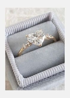 an engagement ring in a box on a table