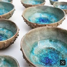 several blue bowls sitting on top of a white table