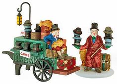 two figurines sitting on top of a cart