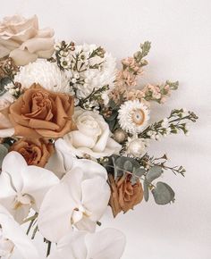 an arrangement of flowers on a white background