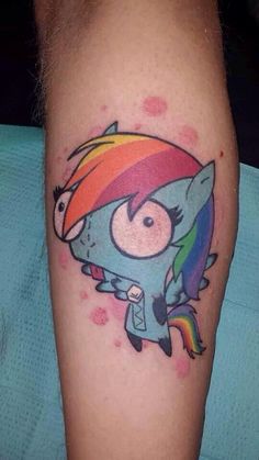 a person with a tattoo on their leg and a rainbow in the middle of it