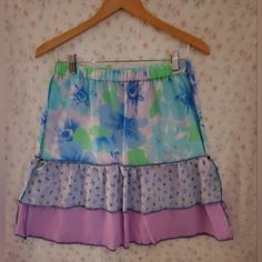 Floral Ruffled Skirt. Floral Cotton Top Tier, Blue Floral Gauze Middle Tier, Lilac Gauze Bottom Tier. Blue Overlocked Serged Contrast Stitching. Elastic Pull On Waist. Size Small. Machine Wash. Hardcore Bombshell Clothing Measurements Are Approximate 13.5" Across Waist 17" Across Hips 21" Long Please Don't Hesitate To Message Me With Any Questions And/Or Comments Prior To Buying. Thank You! #Cottagecore #Cottage #Fairy #Fairycore #Couqutte Summer Fairycore Skirt, Fairy Kei Skirt With Ruffles For Summer, Summer Fairy Kei Skirt With Ruffles, Fairy Kei Style Ruffled Skirt For Summer, Fairy Kei Ruffled Skirt For Summer, Fairy Kei Mini Skirt With Ruffles For Summer, Summer Fairy Kei Mini Skirt With Ruffles, Fairy Kei Ruffled Mini Skirt For Summer, Summer Fairycore Tiered Skirt