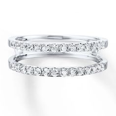 two white gold wedding bands with diamonds on each band and one diamond set in the middle