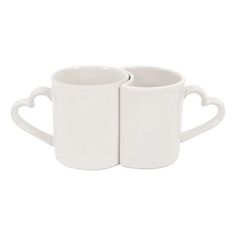 two white coffee mugs with hearts on them