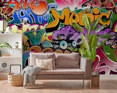 a living room filled with furniture and graffiti covered wallpaper on the side of it