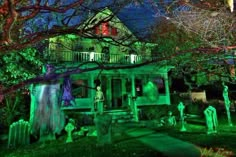 a house decorated for halloween with green lights