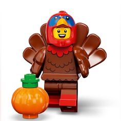 a lego turkey is standing next to an orange