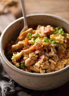 a white bowl filled with rice and vegetables