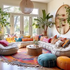 a living room filled with lots of furniture and plants on top of the rugs