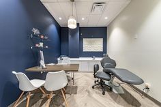 an office with blue walls and white chairs