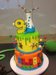 a birthday cake with the number nine on it's top and chemical symbols around it