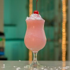 a pink drink sitting on top of a table