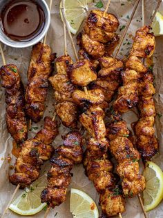 chicken skewers with lemon wedges and ketchup