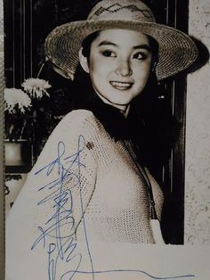 an old photo of a woman wearing a hat