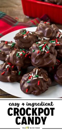 chocolate crockpot candy on a white plate with red and green sprinkles