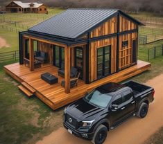 a truck is parked in front of a tiny house