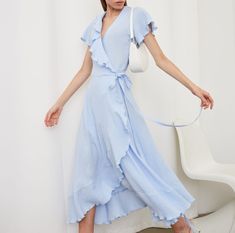 Embrace effortless elegance with our Muslin Cotton Wrap Dress, a perfect blend of comfort and style. This short-sleeved dress with playful ruffles offers a breezy, relaxed fit that flatters any body type. The gauze V-neck design adds a touch of feminine charm, making it an ideal pick for both casual outings and special events. The maxi length ensures a graceful silhouette, while the wrap style allows for adjustable sizing, ensuring a custom fit for all. Our dress, crafted in a beautiful shade of pastel blue, is a must-have wardrobe essential for the fashion-forward woman. Its lightweight fabric is perfect for sunny days or layered styling for cooler evenings. * All clothing made from European muslin (100% cotton) * OEKO-TEX certified fabric (no harmful chemicals used in production) * From Short Sleeves Dress, Cotton Wrap Dress, Wrap Dress Short, Dress With Ruffles, Dressed To The Nines, Layer Style, Sleeves Dress, Charm Making, Sleeved Dress