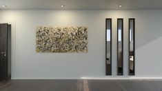 an abstract painting hangs on the wall next to two tall black and white doors in a room