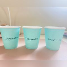 three blue cups sitting on top of a table