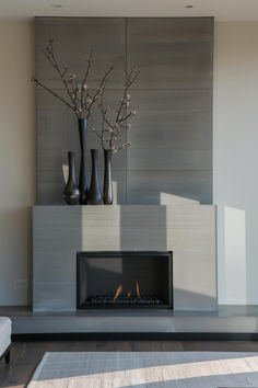 a living room with a fire place and vases