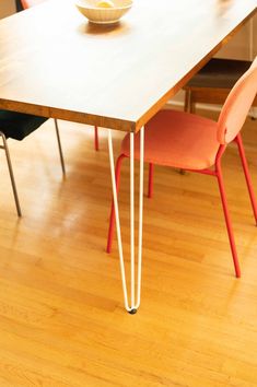 a table with two chairs and a bowl on it